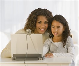 African mother and daughter looking at web cam