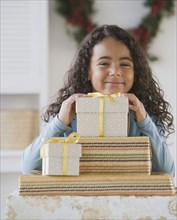African girl behind stack of gifts