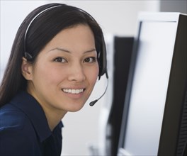 Asian businesswoman wearing headset