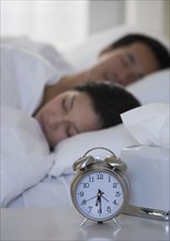 Asian couple sleeping in bed