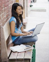 Mixed Race woman typing on laptop