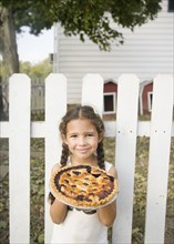Hispanic girl holding homemade pie