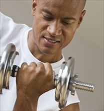 African man lifting dumbbell