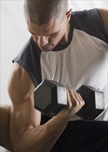 Hispanic man lifting free weights