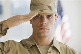 Hispanic male soldier saluting