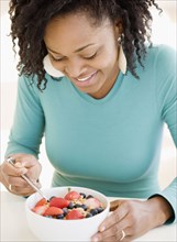 African woman eating cereal