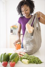 African woman unpacking groceries