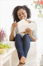 African woman reading mail