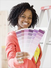 African woman holding paint swatches