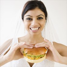 Mixed Race bride eating cheeseburger