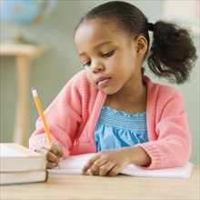 Mixed race girl doing school work