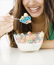 Close up of Middle Eastern woman eating cereal