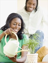 African couple watering plant