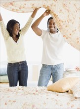 African couple making bed