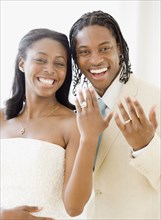 African bride and groom showing wedding rings