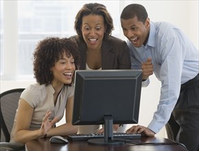 African people looking excited working on computer
