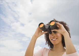 African woman looking through binoculars