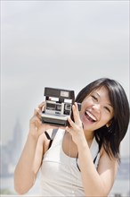 Asian woman with instant camera