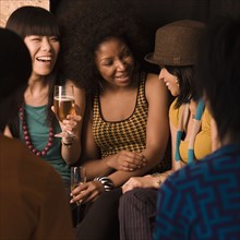 Multi-ethnic friends drinking in nightclub