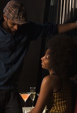 African couple drinking in nightclub