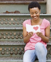African woman reading Valentine's Day card