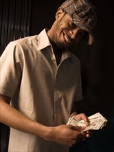 African man counting money