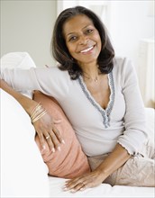 Confident African woman smiling in living room