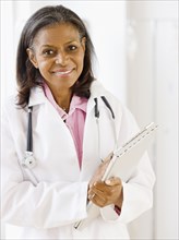 African doctor standing with medical chart