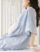 Pregnant Asian woman having checkup in doctor's office