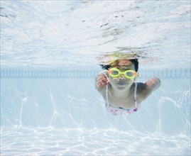 Hispanic girl swimming in pool