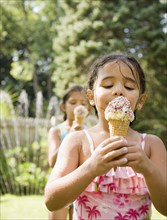 Hispanic girls eating ice cream cones