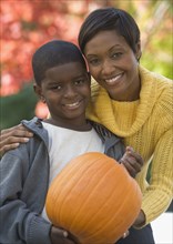African mother and son holding pumpkin