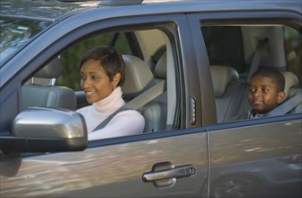 African mother and son driving in car