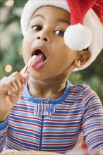 Close up of African American boy licking candy cane