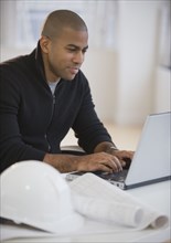 African American architect using laptop