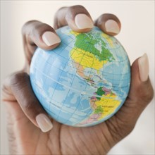 African woman holding globe in hand
