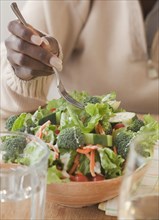 African woman eating healthy salad