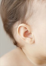 Close up of mixed race baby girl's ear