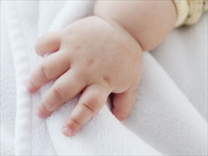 Close up of mixed race baby girl's hand