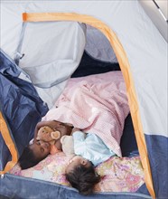 African girls sleeping in tent