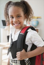 African girl carrying backpack