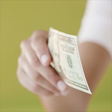 Woman holding twenty dollar bill