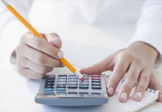 Woman using calculator