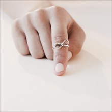 Woman with string tied around forefinger