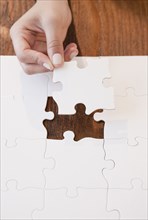 Woman completing jigsaw puzzle