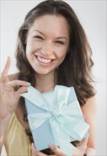 Mixed race woman holding gift