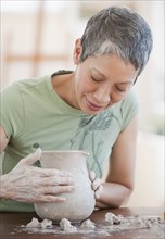 Chinese woman shaping clay pot