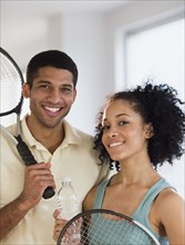 Couple holding tennis rackets