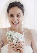 Bride holding handful of money