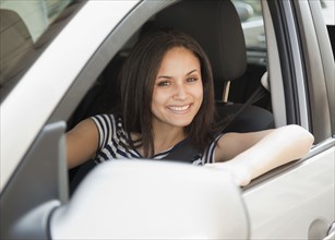 Mixed race woman driving car